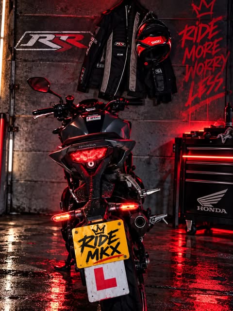 Motorcycle and riding gear in red lighting from RideNRabbit’s post